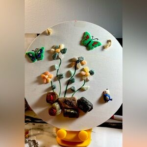 The piece of art made whit wood and stone and clay